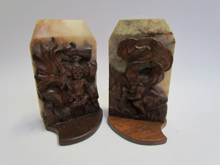 Signed A H Hamer 1947 a pair of marble and carved oak bookends,