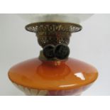 An Edwardian brass based oil lamp with etched shade painted glass reservoir