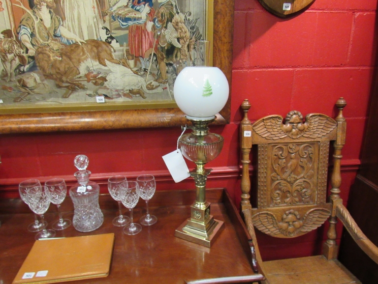 A Victorian oil lamp circa 1885 in brass with a stepped base leading to a reeded column and