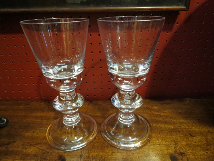 A pair of heavy crystal wine goblets with bulbous stems