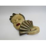 A 1950's plaster wall plaque lady with fan, painted nails and lips,signed verso,