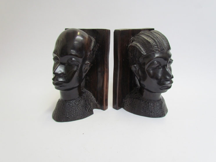 A pair of ebony African female and male bust bookends 19cm tall