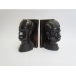 A pair of ebony African female and male bust bookends 19cm tall