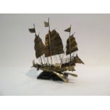 An Oriental white metal model of a "Junk" ship