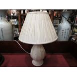 A cream baluster form table lamp with pleated cream shade