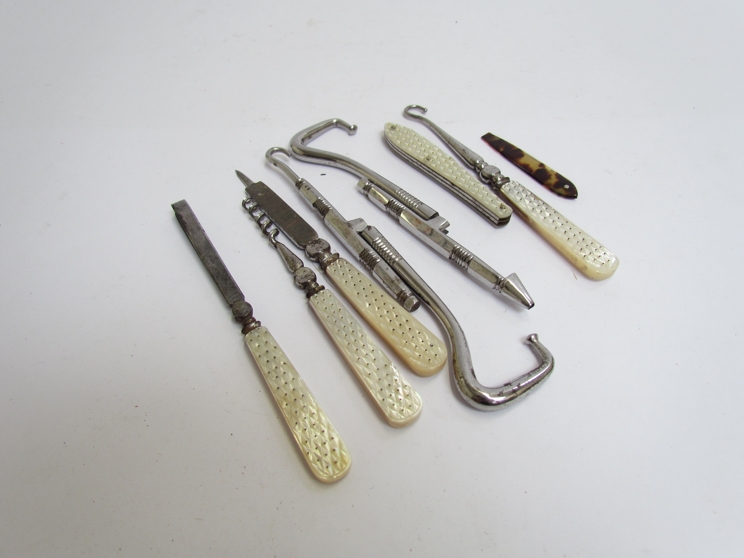 A quantity of mother-of-pearl handled instruments, button hook, tweezers, file,