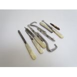 A quantity of mother-of-pearl handled instruments, button hook, tweezers, file,