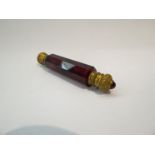 A Victorian ruby glass faceted scent bottle with gilt brass ends