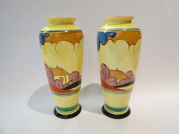 A pair of Clarice Cliff Bizarre Cafe-au-Lait Autumn vases, each of slender baluster form,