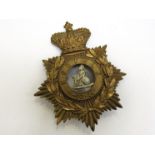 A Norfolk Regiment helmet plate in the 'Honolulu' pattern,