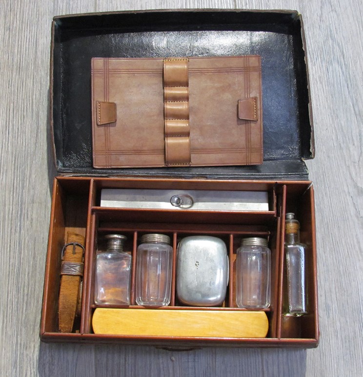 A brown leather campaign style writing case with contents