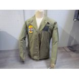 A WWII or after US Navy field jacket with Subron 14 Scottish submarine base badge