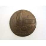 A WWI memorial plaque/death penny named to JOSEPH ERIC YOUNG, a sergeant, service no.
