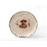 An early 20th Century Baden-Powell plate, the central portrait with shaped gilt border,
