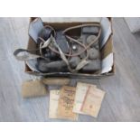 A box of miscellaneous militaria including booklets and field telephones
