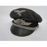 A Third Reich era German Luftwaffe officer's peaked visor cap with Luftwaffe eagle wire badge over