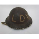 A WWII British Local Defence Volunteers (LDV) helmet with liner and chin strap