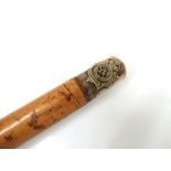 A walking cane with George Crown Army service corps badge