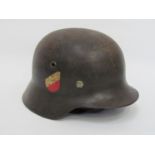 A Third Reich era German M35 helmet with double decals consisting of Luftwaffe eagle and swastika