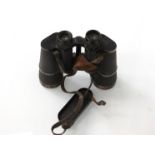 A WWII German pair of Dienstglas 10x50 army binoculars with Bakelite eye cover and leather straps