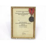 A WWII German Eastern Front medal 1941/42 together with certificate named OGEFR. ANTON KRUPICA I.