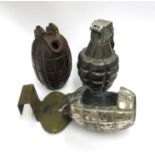 Three grenades: British Mills (no fittings), another cut-out for display, and a pineapple grenade.