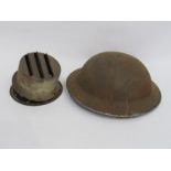 A WWII British Brodie helmet with chinstrap and liner,