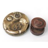 A brass ashtray bearing SS emblem and Hitler side portrait,