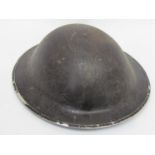 A WWII Brodie helmet, blackened for civil use,
