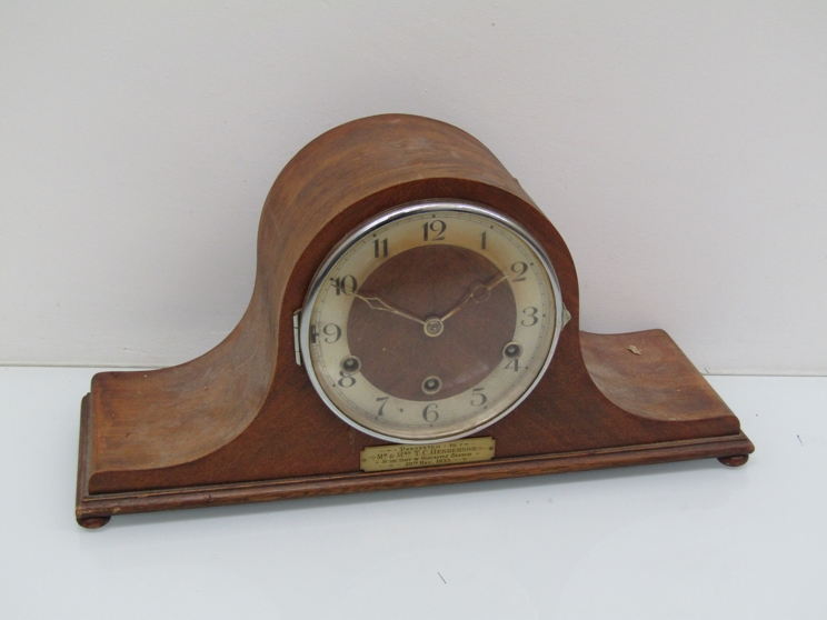 A 1930's walnut cased Napoleon hat mantel clock with striking and chiming movement,