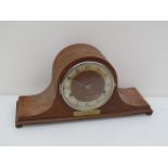 A 1930's walnut cased Napoleon hat mantel clock with striking and chiming movement,