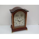 An Edwardian mahogany and satin inlaid bracket clock with silvered Arabic dial,