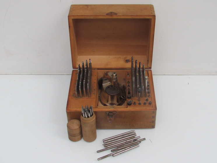 A cased watchmaker's staking set with a selection of punches