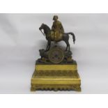 A French Empire period bronze and cast brass mantel clock depicting an Arabian gentleman mounted on