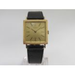 ROLEX: a mid 20th Century gold cased gent's wristwatch of square form, ribbed bezel and dial,