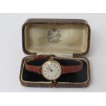 ROLEX: an early 20th Century 9ct gold cased wristwatch with silvered Arabic dial,