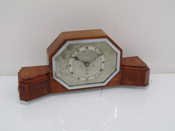 An Art Deco walnut cased timepiece with chrome bezel and feet, Elliott movement,