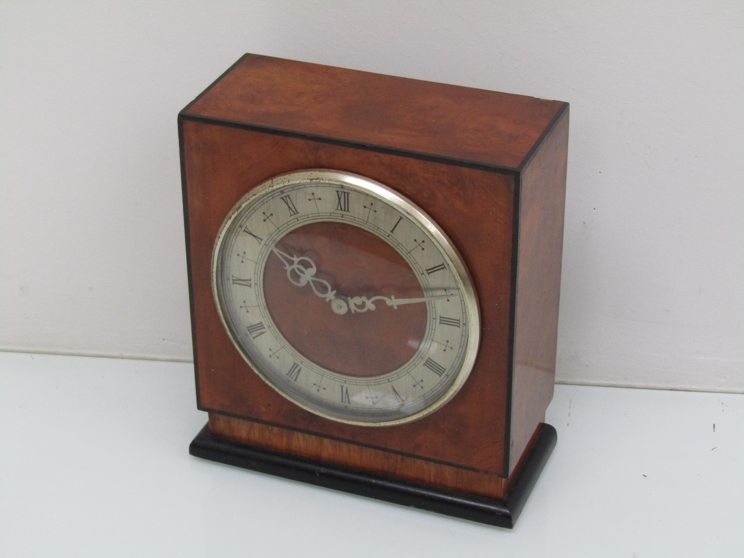 A Thomas Mercer walnut and ebonised mantel time piece,