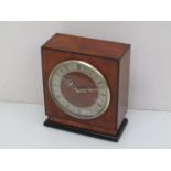 A Thomas Mercer walnut and ebonised mantel time piece,