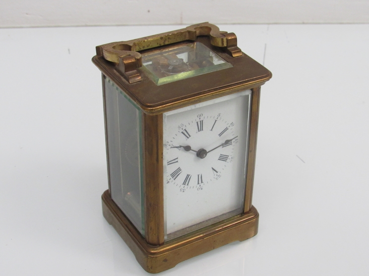 An early 20th Century brass cased single train carriage timepiece with platform escapemen,