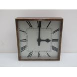 An early to mid 20th Century electric wall clock of square form with silver plated bezel,