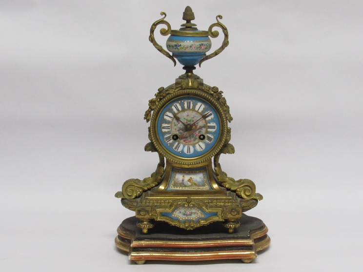 A 19th Century French Ormolu mantle clock with raised urn finial over Roman hand-painted dial,