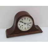 An early 20th Century oak Napoleon hat striking mantel clock, key and pendulum,