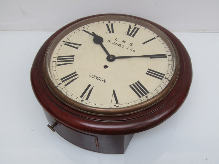 An early 20th Century mahogany cased 12" station dial clock with painted metal Roman dial signed