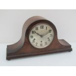 An early 20th Century oak Napoleon hat striking and chiming mantel clock, key and pendulum,