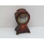 An Edwardian mahogany and inlaid mantel clock for balloon form, silvered Arabic dial,