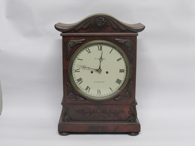 A 19th Century English flame mahogany bracket clock with painted metal Roman dial signed Jn.