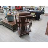 An Edwardian oak revolving bookshelf on castors