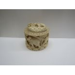 An early 20th Century ivory box carved with lions and elephants,