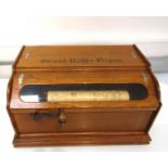 A Grand Roller Organ 32 key action, by the Autophone USA Company in light oak case,